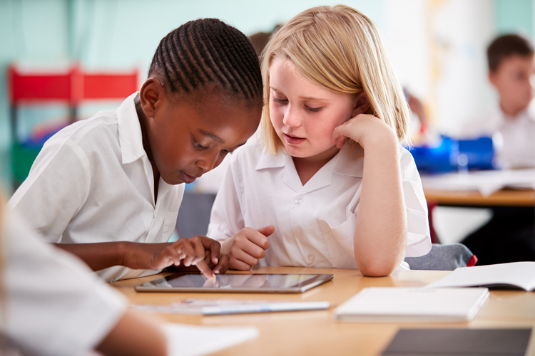 Students in class using tablets